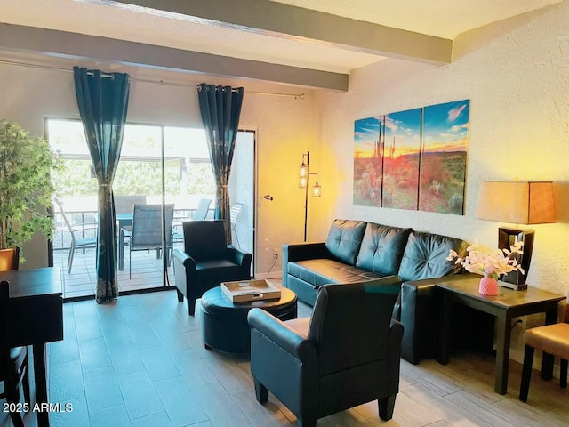 living room with beam ceiling and a textured wall