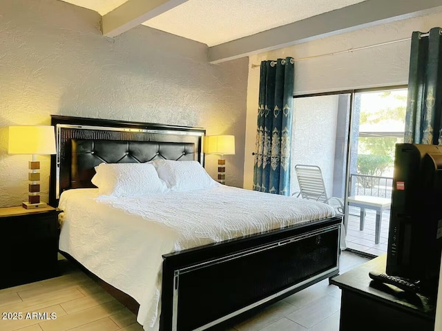 bedroom with beam ceiling, a textured wall, and a textured ceiling