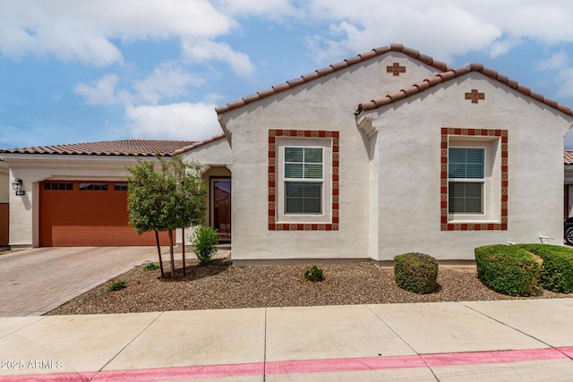4044 E Dawson Dr E, Chandler, AZ 85249 - mediterranean / spanish house featuring decorative driveway, an attached garage, stucco siding, and a tiled roof