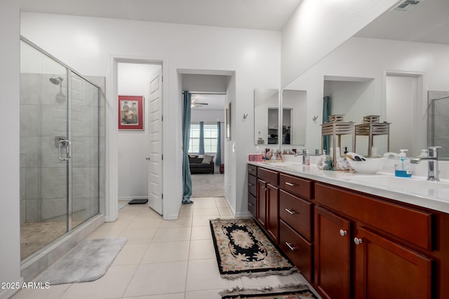 4044 E Dawson Dr E, Chandler, AZ 85249 - ensuite bathroom with a stall shower, double vanity, tile patterned floors, and baseboards