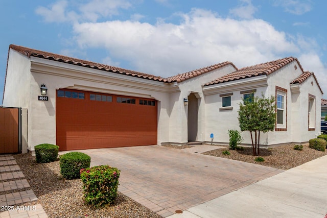 4044 E Dawson Dr E, Chandler, AZ 85249 - mediterranean / spanish house featuring decorative driveway, an attached garage, stucco siding, and a tile roof
