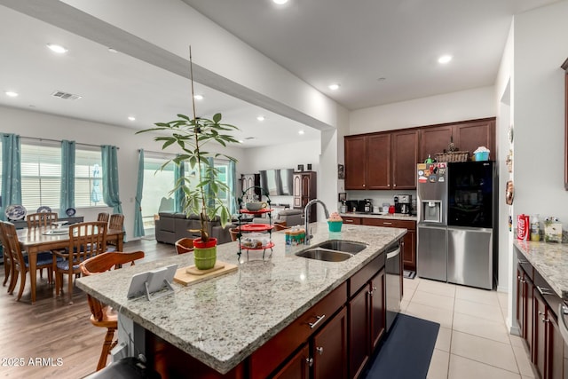 4044 E Dawson Dr E, Chandler, AZ 85249 - kitchen with appliances with stainless steel finishes, a sink, an island with sink, recessed lighting, and light stone counters