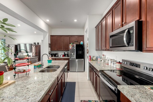 4044 E Dawson Dr E, Chandler, AZ 85249 - kitchen with stainless steel appliances, a sink, light stone countertops, light tile patterned floors, and recessed lighting