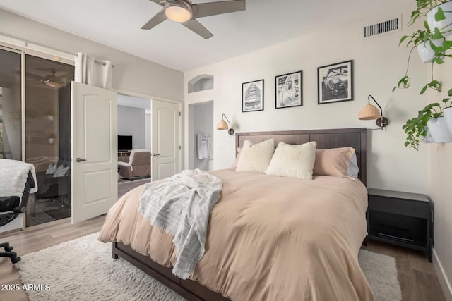 bedroom with ceiling fan and hardwood / wood-style floors