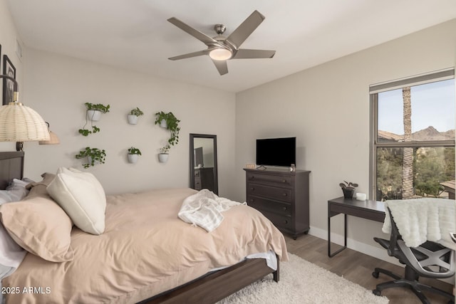 bedroom with hardwood / wood-style flooring and ceiling fan