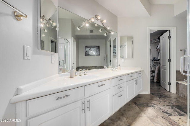 bathroom featuring vanity and an enclosed shower