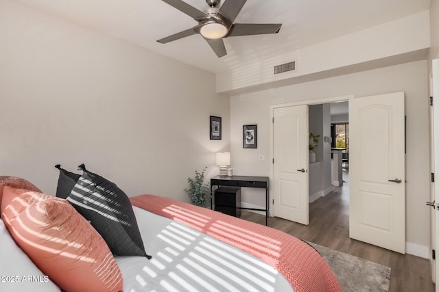 bedroom with ceiling fan and dark hardwood / wood-style floors