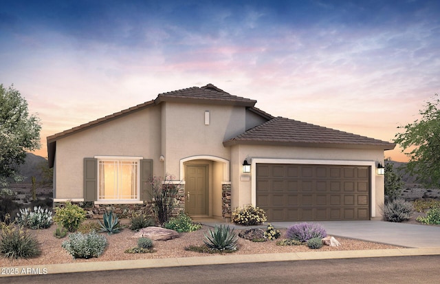 2600 N Coronado Dr, Florence, AZ 85132 - view of front of house featuring a garage, stucco siding, a tiled roof, concrete driveway, and stone siding