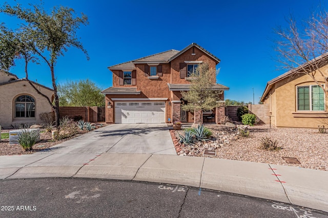 view of front of home featuring stucco siding, driveway, a garage, and fence