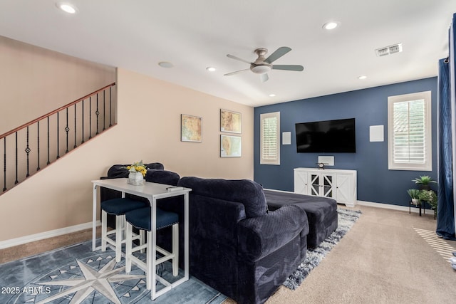 carpeted living room featuring visible vents, recessed lighting, stairway, and baseboards