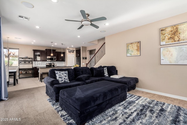 living area featuring visible vents, baseboards, stairway, light colored carpet, and recessed lighting