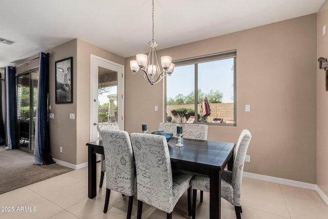 dining space featuring light tile patterned floors, visible vents, baseboards, and a chandelier