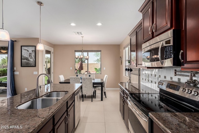 kitchen featuring decorative light fixtures, visible vents, appliances with stainless steel finishes, and a sink