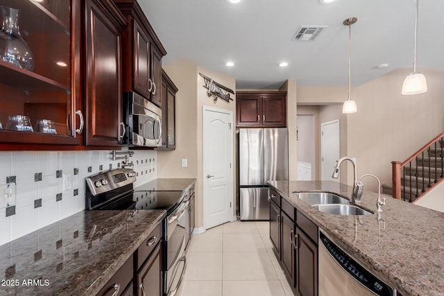 kitchen featuring light tile patterned floors, visible vents, a sink, decorative backsplash, and appliances with stainless steel finishes