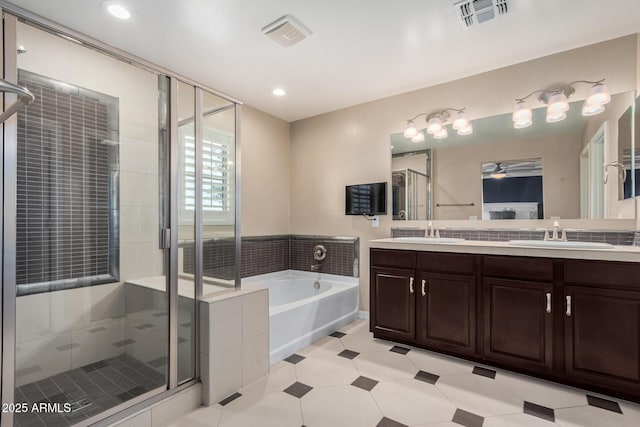 bathroom featuring a sink, visible vents, a garden tub, and a shower stall