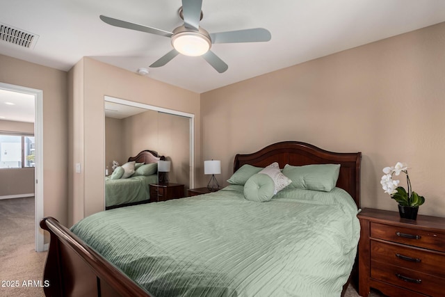 carpeted bedroom with visible vents, a closet, and ceiling fan