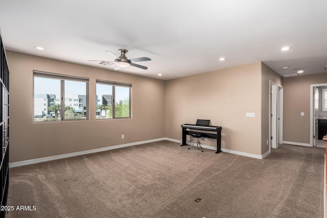 carpeted spare room with recessed lighting, a healthy amount of sunlight, baseboards, and ceiling fan