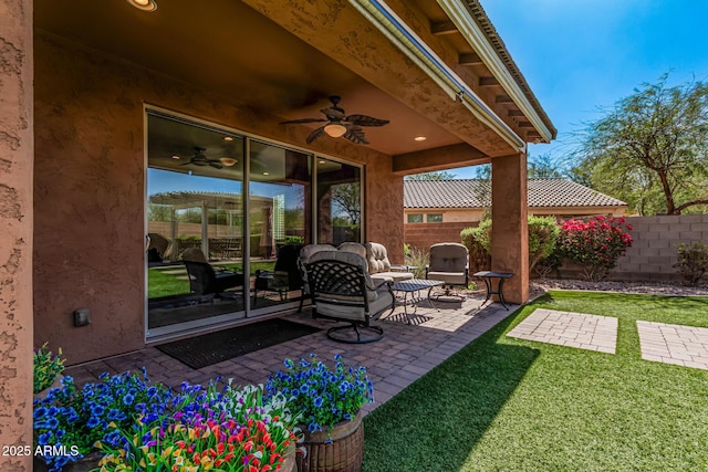 view of patio / terrace featuring ceiling fan and fence