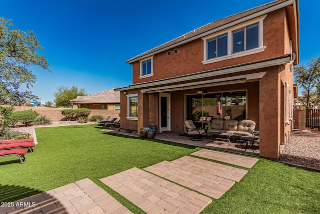 rear view of property featuring stucco siding, an outdoor hangout area, a yard, a fenced backyard, and a patio