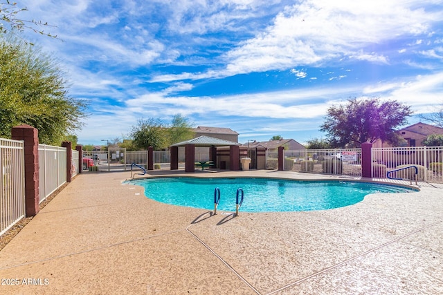 pool featuring a gazebo, a patio, and fence