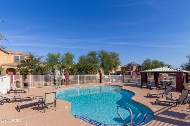 pool featuring a gazebo, a patio area, and fence