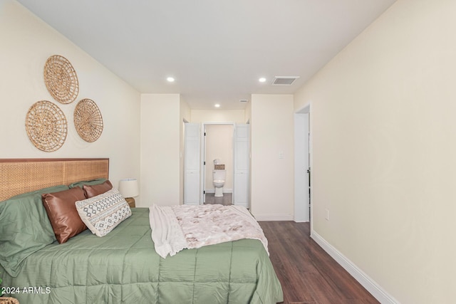 bedroom with dark hardwood / wood-style floors and ensuite bath