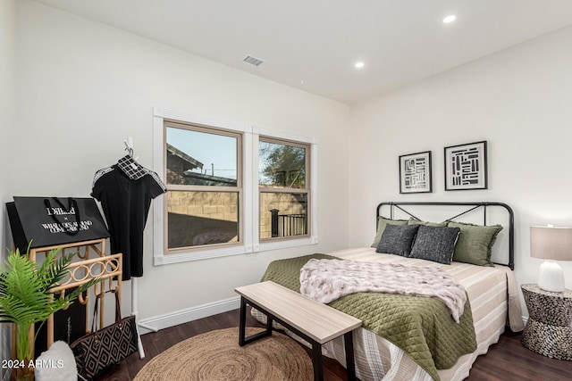 bedroom with dark hardwood / wood-style floors