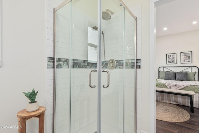 bathroom with hardwood / wood-style floors and walk in shower