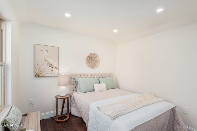 bedroom with dark hardwood / wood-style flooring