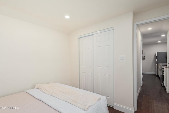 bedroom featuring dark hardwood / wood-style flooring and a closet