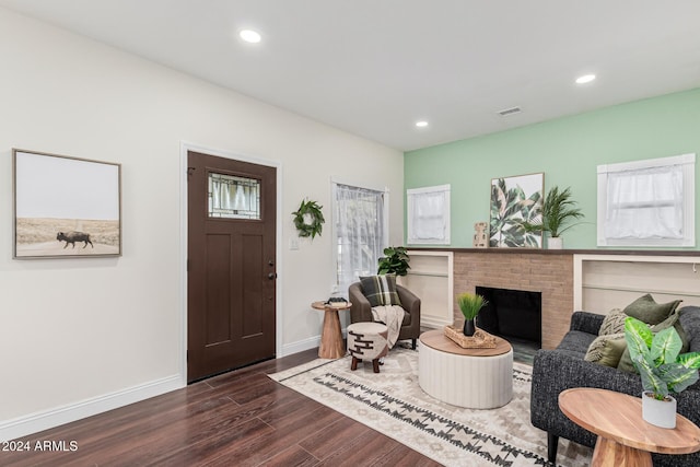 living room featuring a fireplace and dark hardwood / wood-style flooring