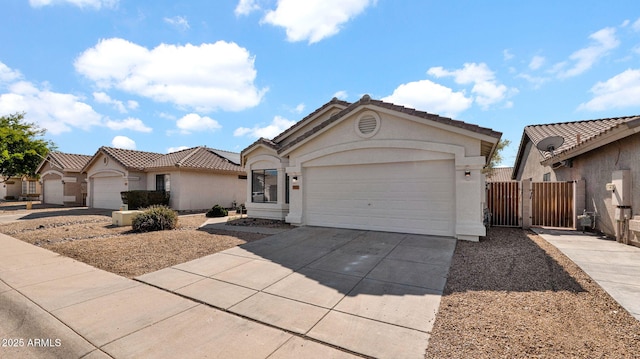 view of front facade featuring driveway, a tiled roof, an attached garage, and stucco siding