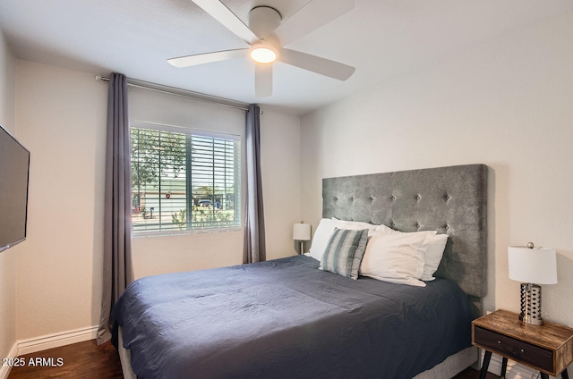 bedroom with ceiling fan and dark hardwood / wood-style floors