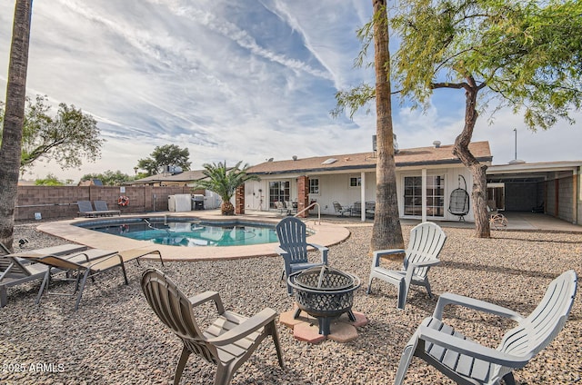 view of swimming pool with a patio and an outdoor fire pit