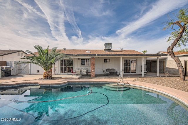 view of pool featuring central air condition unit, area for grilling, and a patio