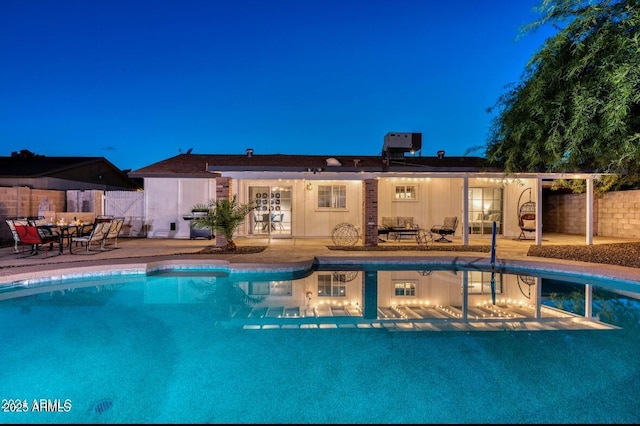 view of pool with cooling unit, a patio, and an outdoor hangout area