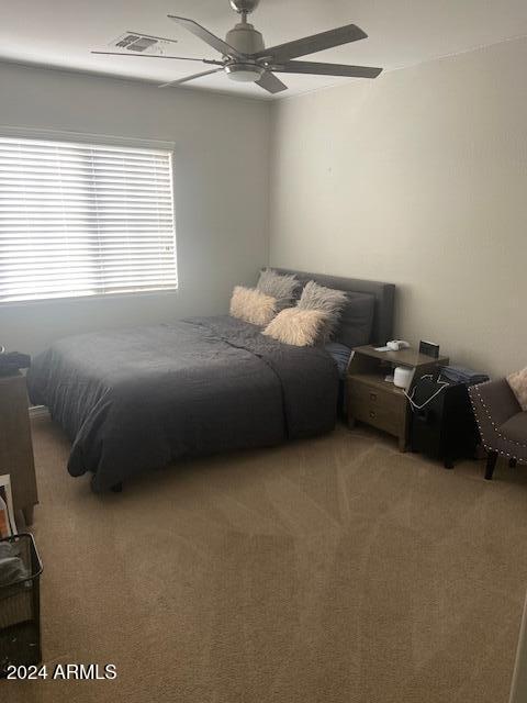 bedroom with ceiling fan and carpet floors