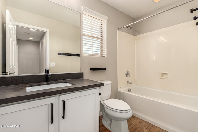 full bathroom featuring vanity, shower / washtub combination, hardwood / wood-style flooring, and toilet