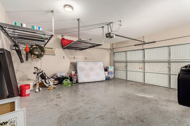 garage with a wall mounted air conditioner and a garage door opener