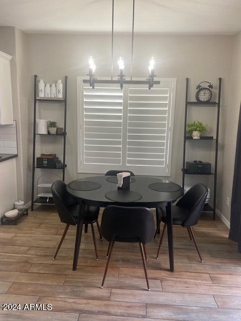 dining room featuring hardwood / wood-style flooring and an inviting chandelier