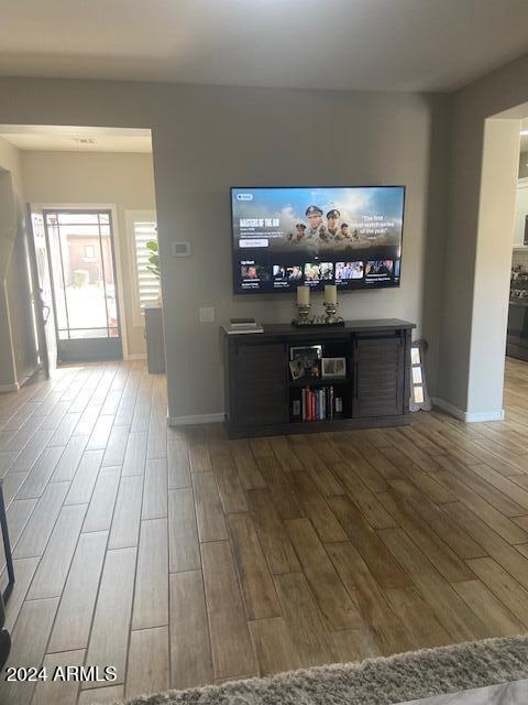 unfurnished living room with wood-type flooring