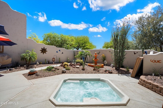 view of pool featuring a fenced backyard, an in ground hot tub, and a patio area