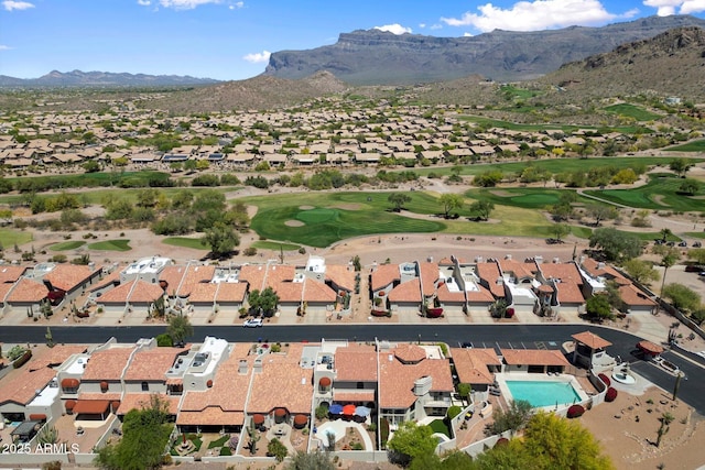 drone / aerial view with a residential view, a mountain view, and golf course view