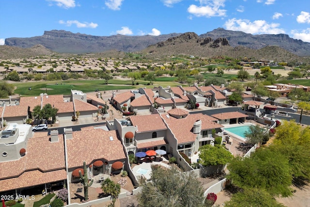 birds eye view of property featuring view of golf course, a residential view, and a mountain view