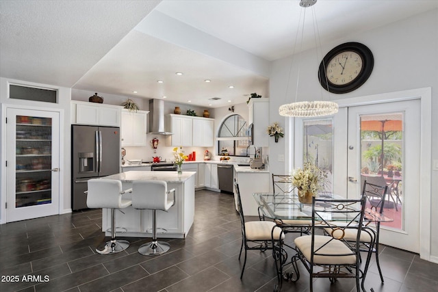 dining space with recessed lighting and dark tile patterned floors