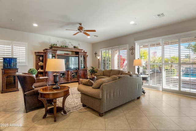 tiled living room featuring ceiling fan