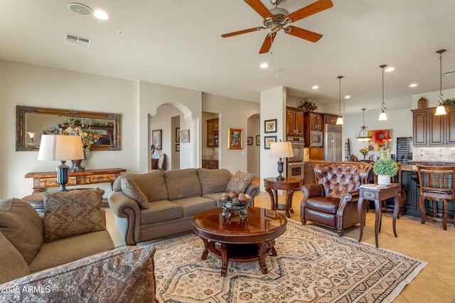 living room featuring ceiling fan and light tile patterned flooring