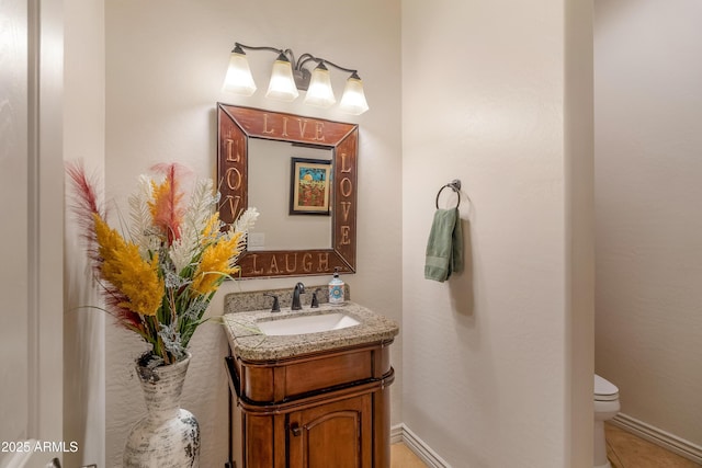 bathroom with toilet and vanity