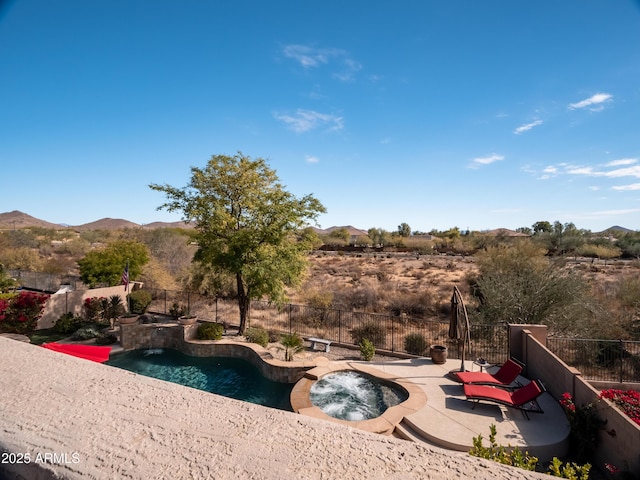 view of pool with a mountain view, an in ground hot tub, pool water feature, and a patio