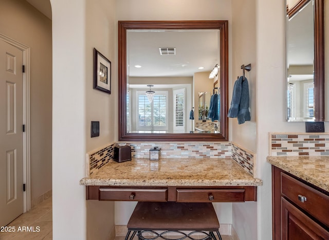 bathroom featuring tasteful backsplash, vanity, and tile patterned floors